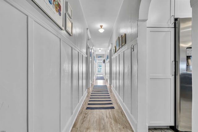 hallway with light hardwood / wood-style flooring