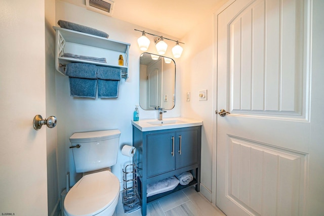 bathroom featuring tile patterned floors, vanity, and toilet