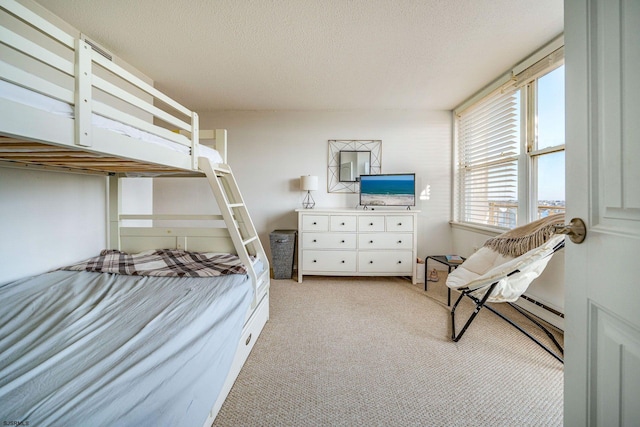 carpeted bedroom with a textured ceiling