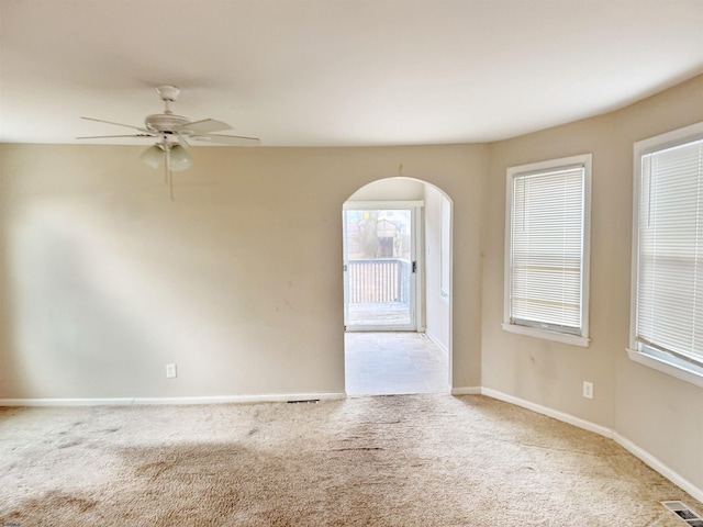 spare room with ceiling fan and light carpet