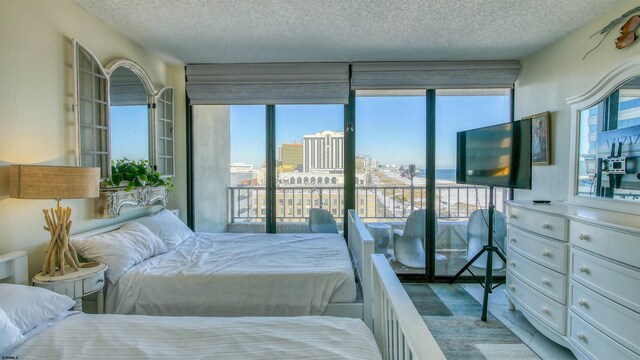 bedroom featuring a textured ceiling and multiple windows