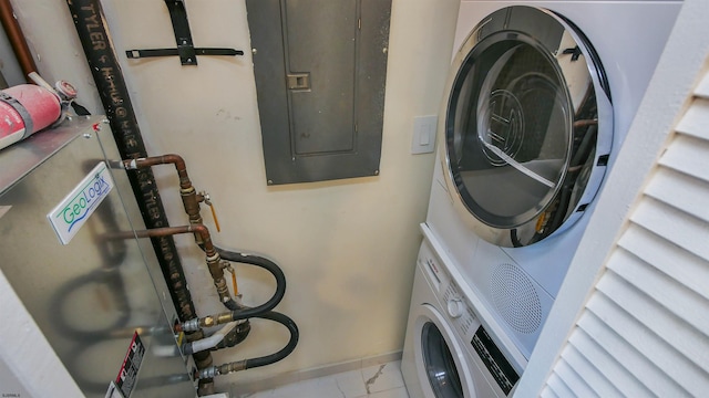 laundry room with stacked washer and dryer and electric panel