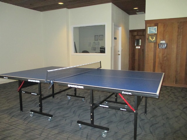 game room with dark colored carpet