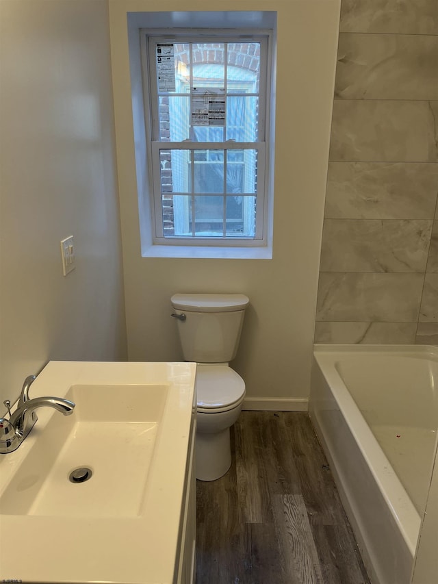 full bathroom with hardwood / wood-style floors, shower with separate bathtub, toilet, and sink