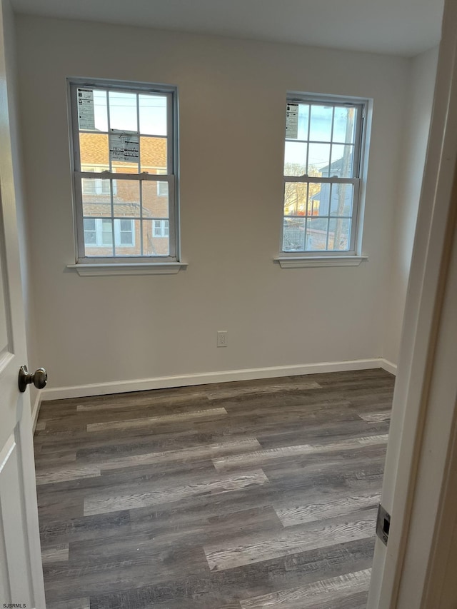 unfurnished room featuring dark wood-type flooring