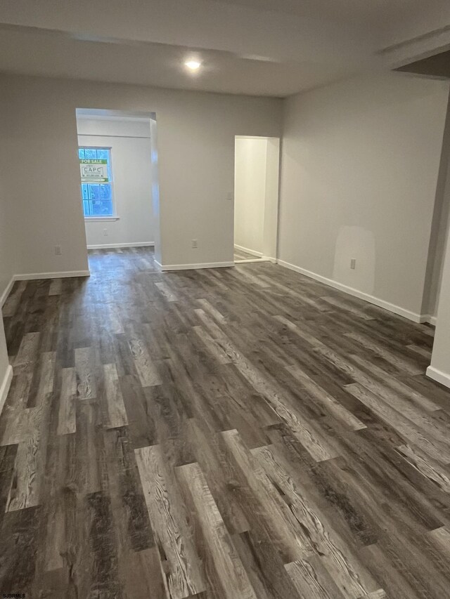 unfurnished room featuring dark wood-type flooring