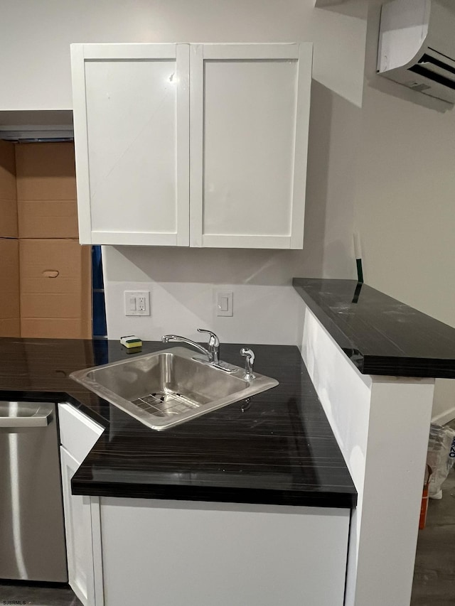 kitchen with white cabinets, stainless steel dishwasher, and sink