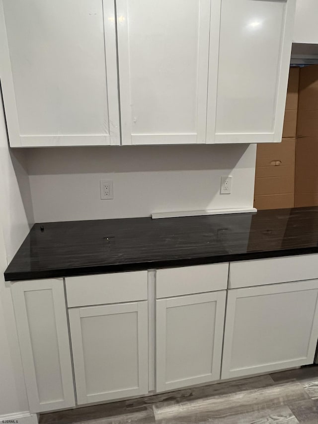 interior space featuring white cabinetry and light hardwood / wood-style flooring