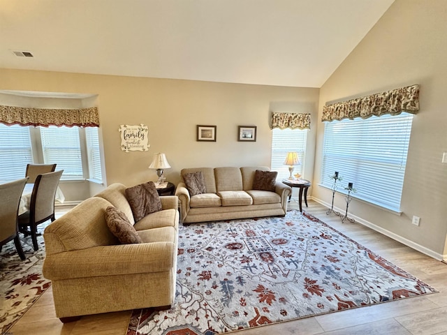 living room with lofted ceiling and light wood-type flooring