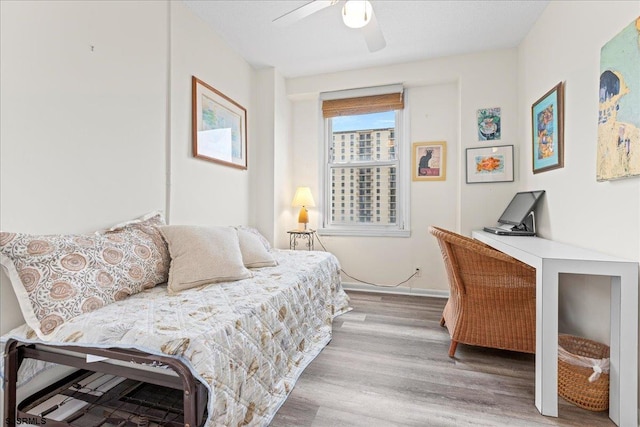 bedroom with hardwood / wood-style floors and ceiling fan