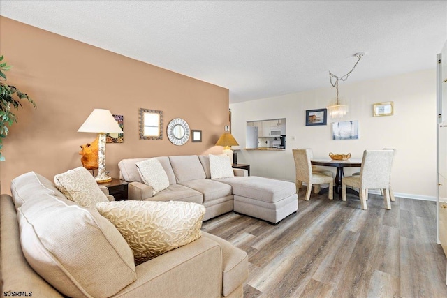 living room with hardwood / wood-style floors and a textured ceiling