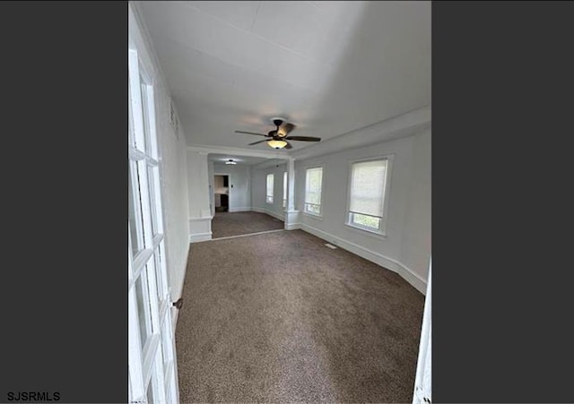 unfurnished living room featuring carpet flooring and ceiling fan