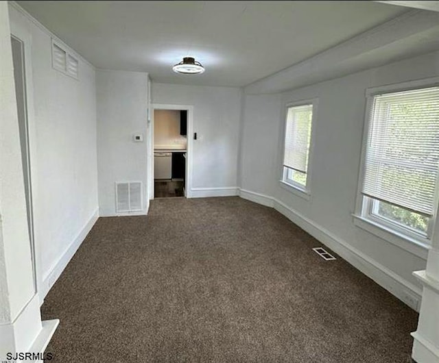 empty room with dark colored carpet