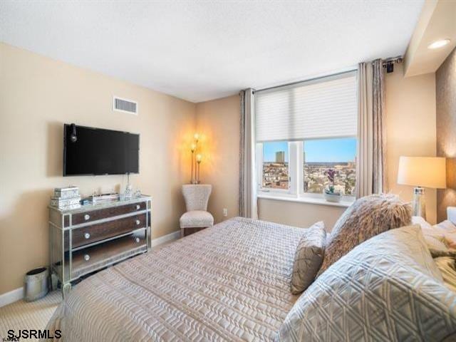 bedroom featuring light colored carpet