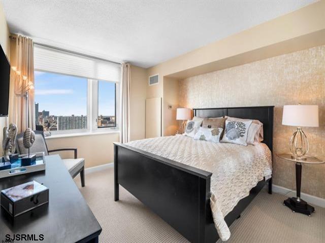 bedroom with light colored carpet