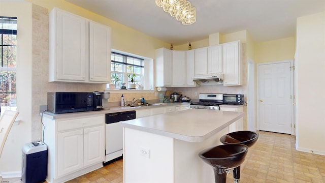 kitchen featuring stainless steel range oven, sink, dishwasher, a kitchen island, and white cabinets