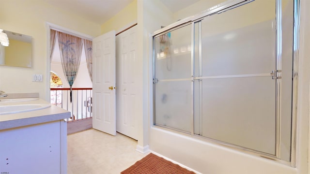 bathroom featuring vanity and shower / bath combination with glass door