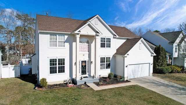 view of front of home with a garage and a front yard