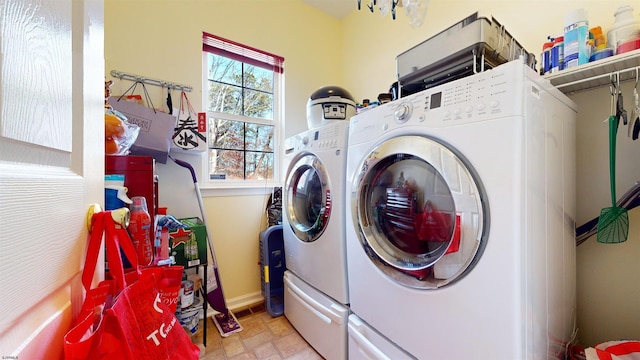 washroom with washing machine and clothes dryer