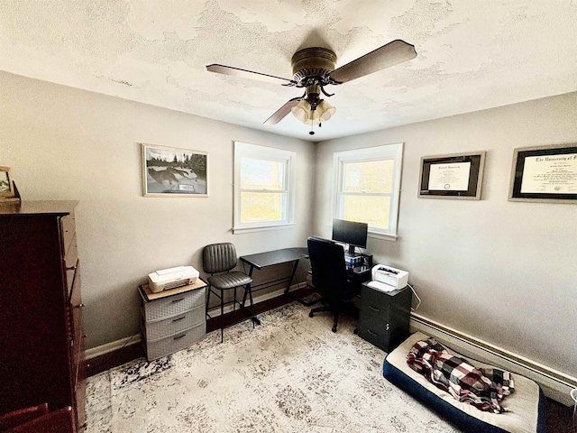 office with a ceiling fan, a textured ceiling, and baseboards