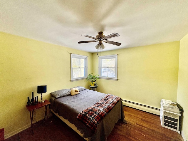 bedroom with heating unit, a ceiling fan, a baseboard heating unit, and dark wood-type flooring