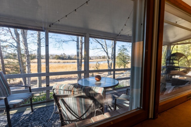 sunroom / solarium with rail lighting and a healthy amount of sunlight