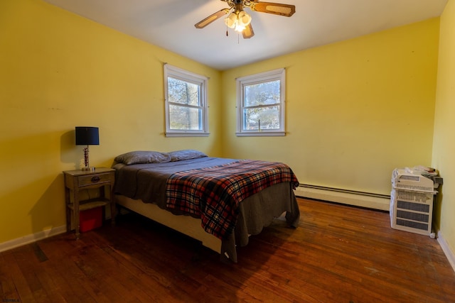 bedroom featuring a baseboard heating unit, a ceiling fan, baseboards, and dark wood-style floors