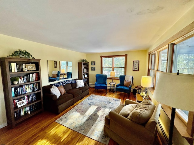 living room featuring baseboard heating and wood finished floors