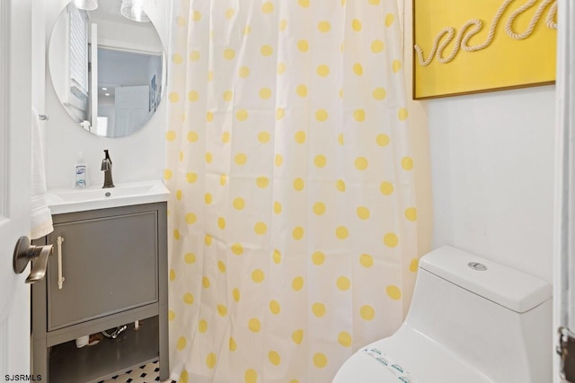 bathroom featuring vanity and toilet