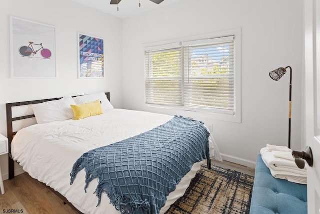 bedroom featuring dark hardwood / wood-style floors and ceiling fan