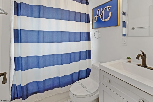 bathroom with a shower with curtain, toilet, and vanity