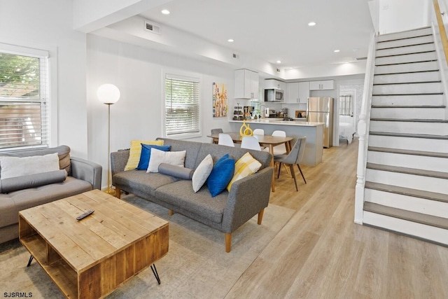 living room with sink and light wood-type flooring