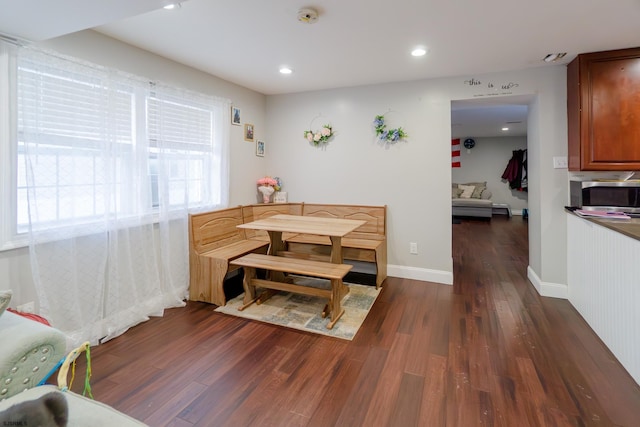 dining space with dark hardwood / wood-style floors