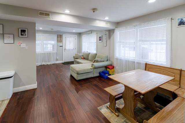 living room featuring a wealth of natural light and dark hardwood / wood-style floors