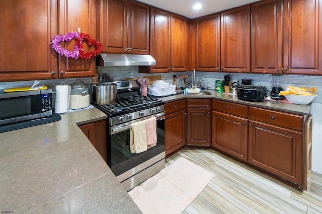 kitchen featuring backsplash, sink, and stainless steel appliances