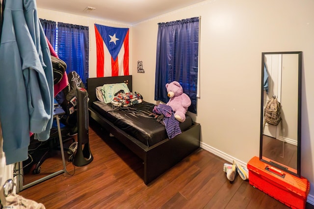 bedroom with dark hardwood / wood-style floors