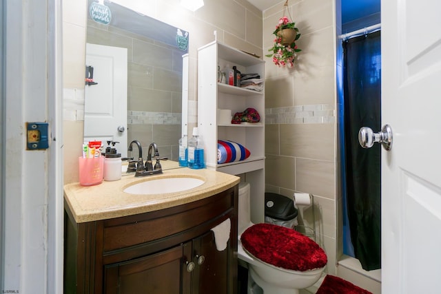 bathroom with a shower with shower curtain, vanity, toilet, and tile walls