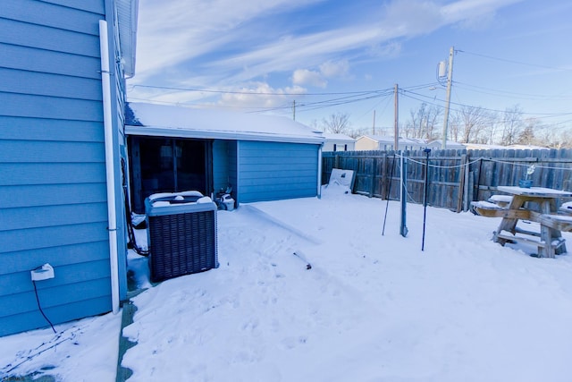 yard covered in snow with cooling unit