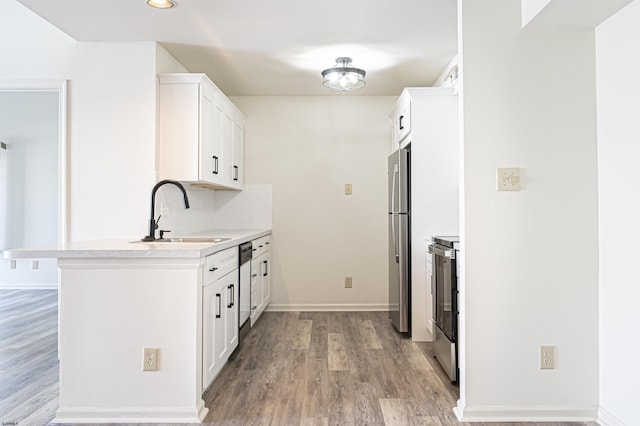 kitchen featuring white cabinets, stainless steel appliances, tasteful backsplash, and sink