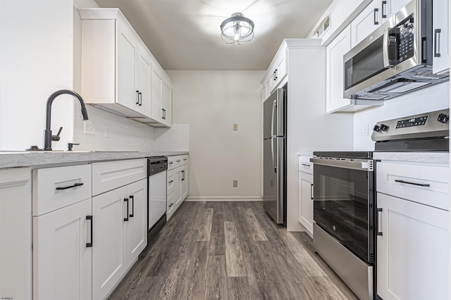 kitchen featuring white cabinetry, dark wood-type flooring, and appliances with stainless steel finishes