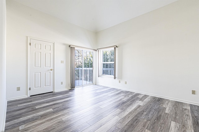 spare room with dark hardwood / wood-style flooring