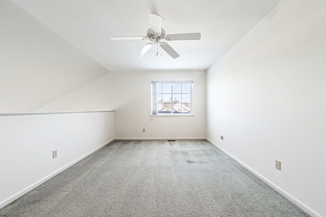 additional living space featuring light carpet, ceiling fan, and lofted ceiling