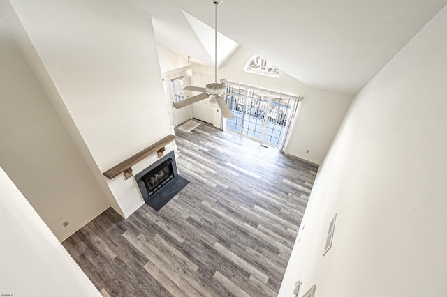 unfurnished living room featuring hardwood / wood-style flooring, high vaulted ceiling, and ceiling fan