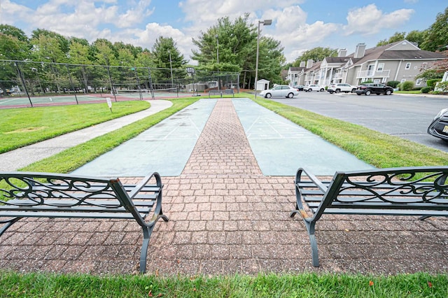 view of community with tennis court