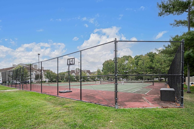 view of sport court with a yard