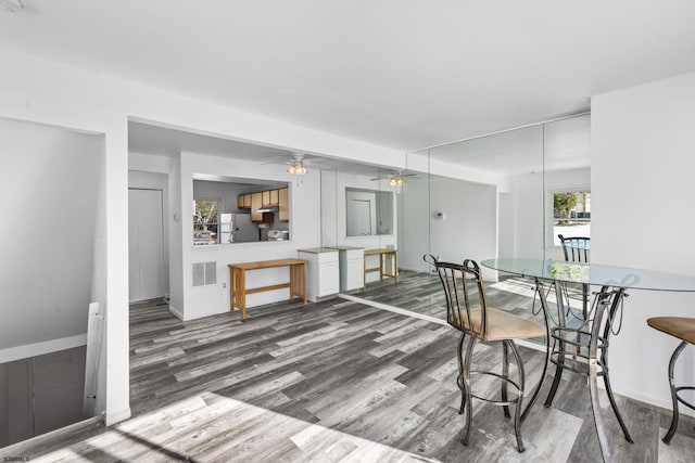 dining area with hardwood / wood-style flooring and ceiling fan