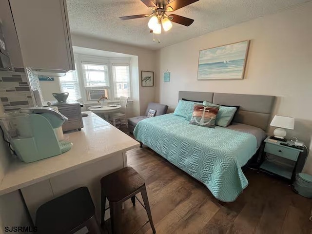 bedroom featuring a textured ceiling, ceiling fan, and dark wood-type flooring