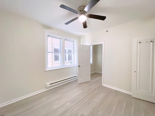 unfurnished bedroom with baseboard heating, ceiling fan, and light hardwood / wood-style floors