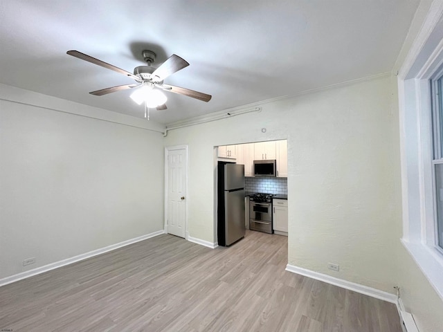 interior space with light wood-type flooring, ceiling fan, and ornamental molding