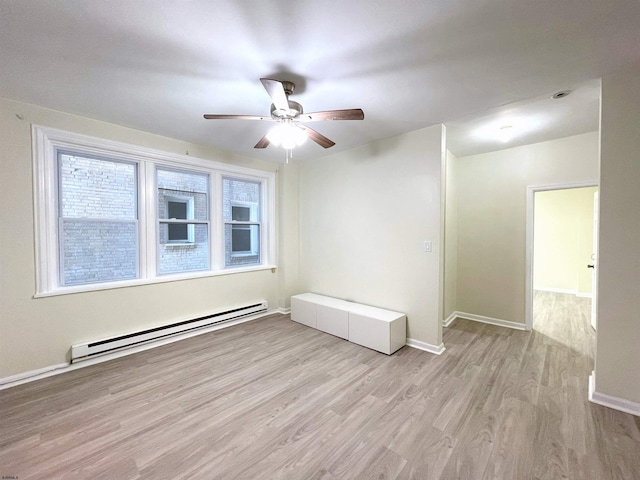 unfurnished room with ceiling fan, baseboard heating, and light hardwood / wood-style flooring